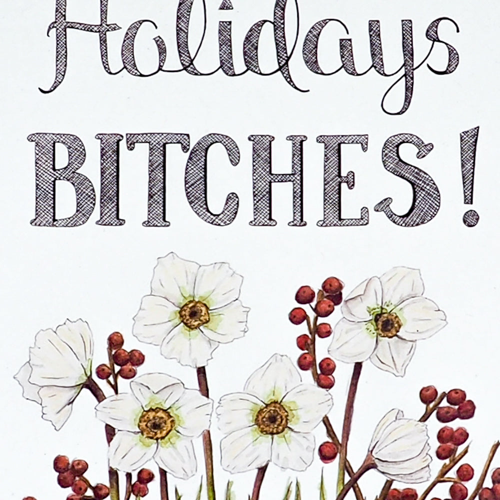Close up of card that says Happy Holidays Bitches with Red Envelope